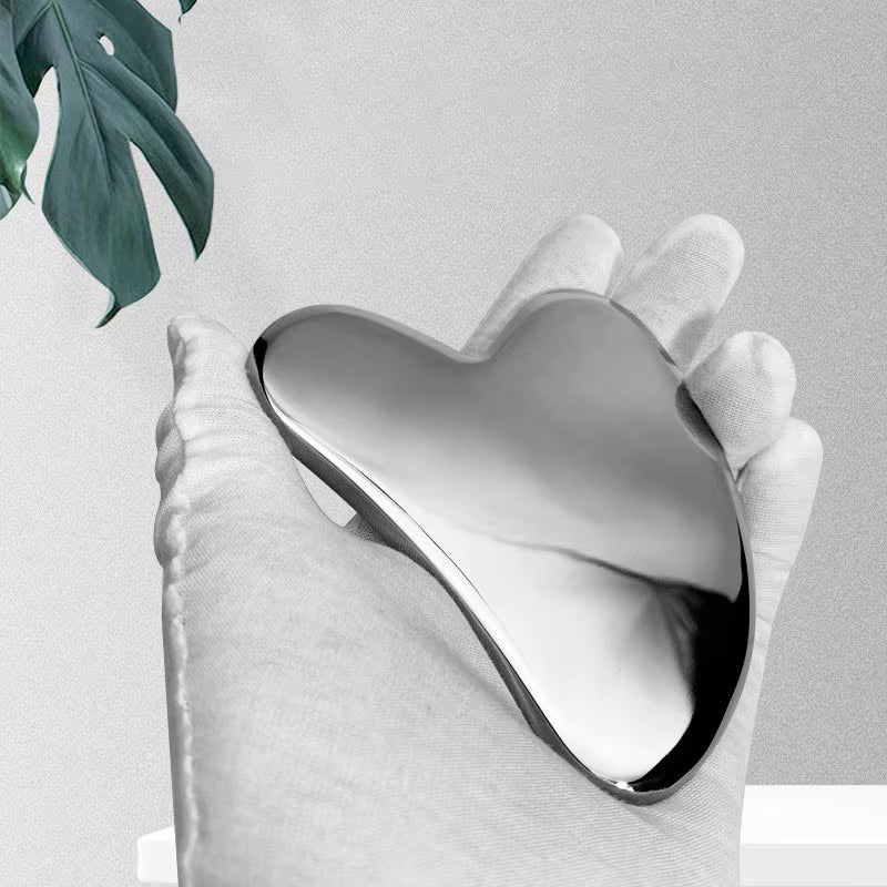 Facial Stainless Steel Scraper in Gloved Hand